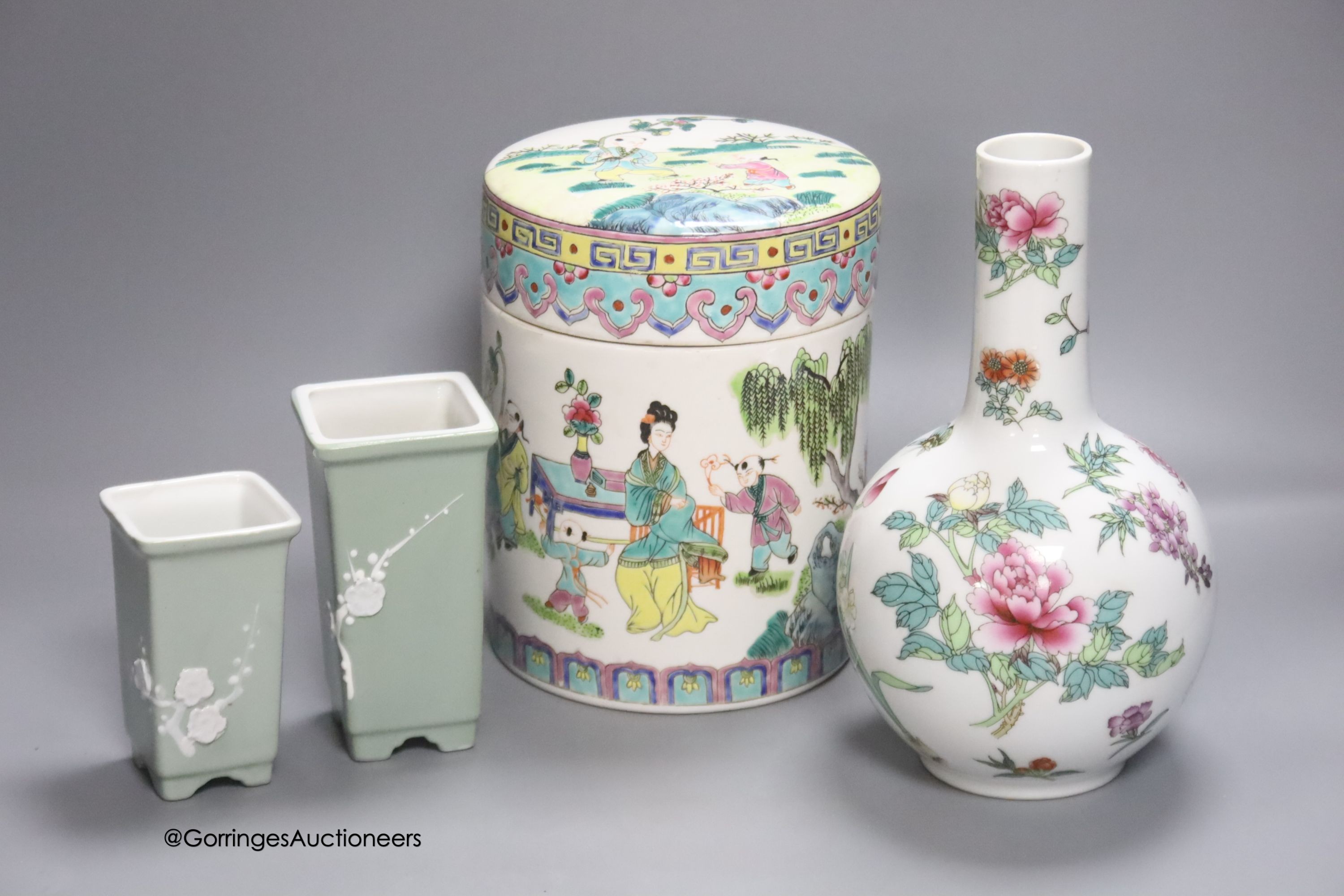 A Chinese famille rose bottle vase and a similar jar and cover and two celadon glazed vases, tallest 24cm